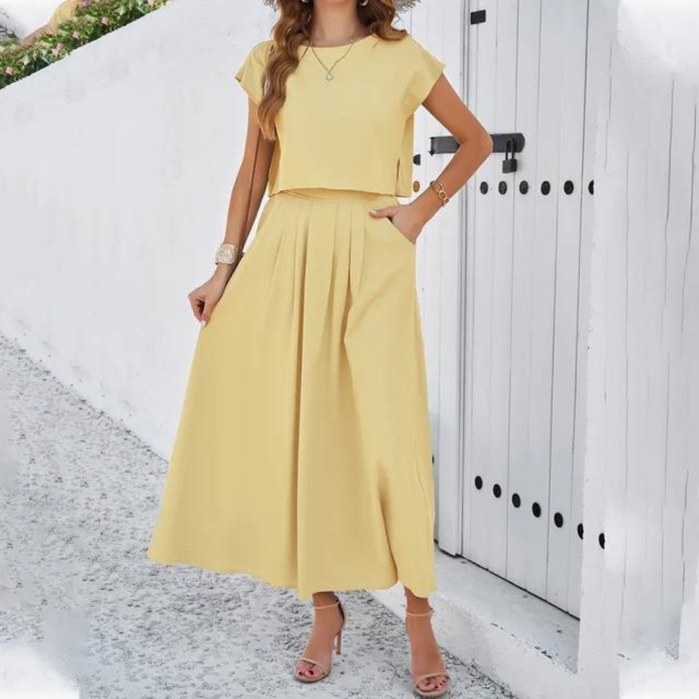 Elegante outfit met crop top en lange vloeiende rok, perfect voor een verfijnde en moderne look, ideaal voor speciale avonden.