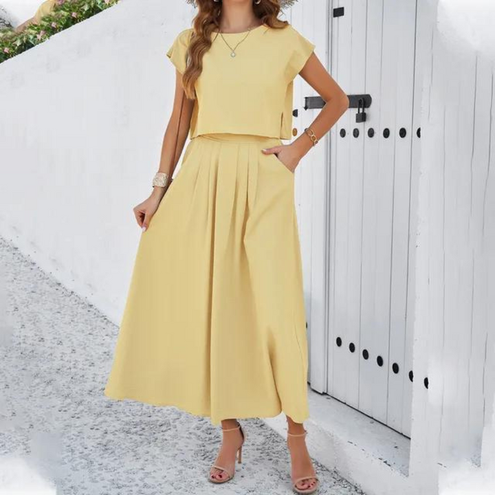 Elegante outfit met crop top en lange vloeiende rok, perfect voor een verfijnde en moderne look, ideaal voor speciale avonden.