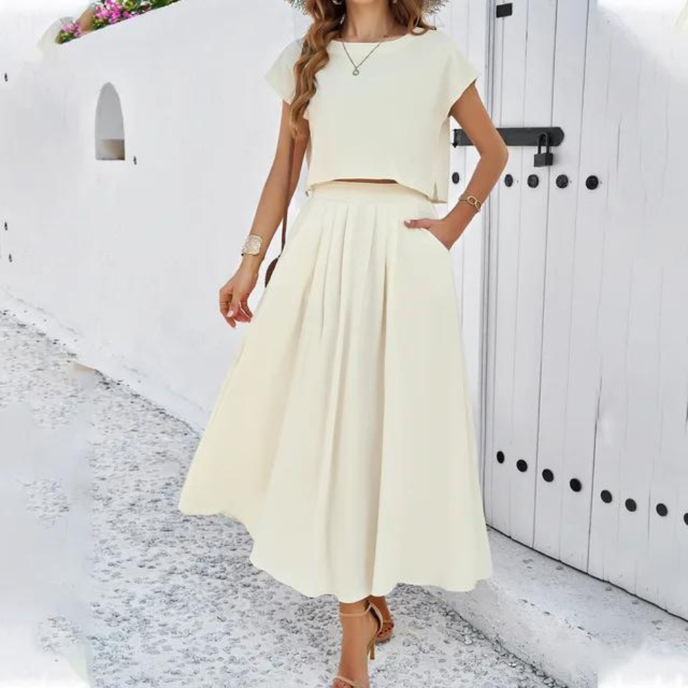 Elegante outfit met crop top en lange vloeiende rok, perfect voor een verfijnde en moderne look, ideaal voor speciale avonden.